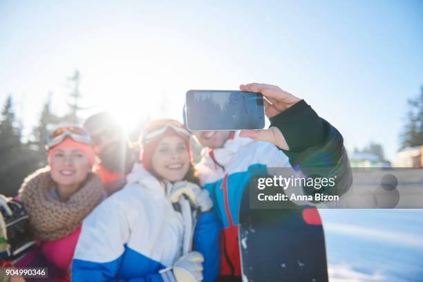 snowboarders taking selfie on the hill. zakopane, poland - anna bergman stockfoto's en -beelden