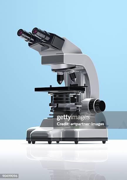 white microscope on blue background - mikroskop stock-fotos und bilder