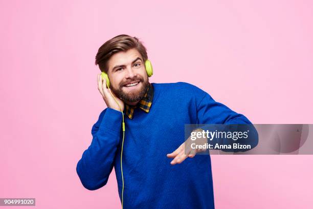 man listening to music by headphones. debica, poland - dj portrait stock pictures, royalty-free photos & images