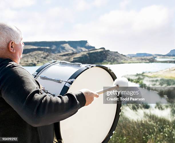 man playing bass drum overlooking river - moses lake wa stock pictures, royalty-free photos & images