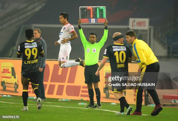 This photo taken on January 10, 2018 shows an Indian referee holding up the substitute board during the Indian Super League football match between...