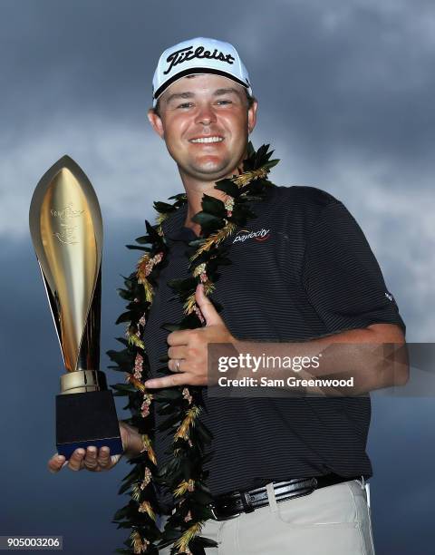 Patton Kizzire of the United States poses with the trophy after winning the Sony Open In Hawaii on the sixth playoff hole against James Hahn at...