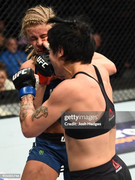 Jessica-Rose Clark of Australia punches Paige VanZant in their women's flyweight bout during the UFC Fight Night event inside the Scottrade Center on...