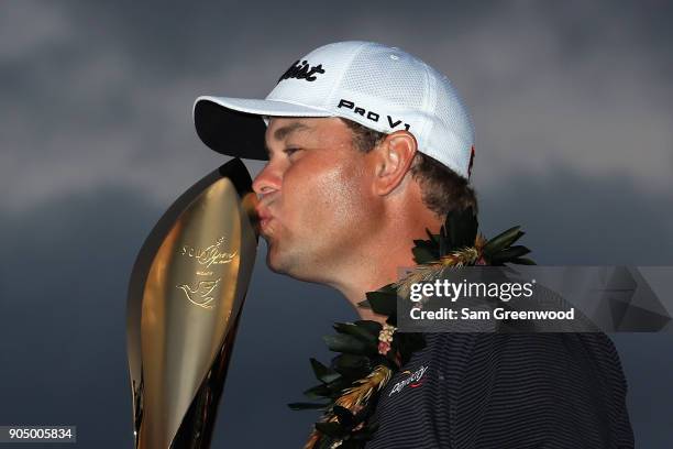 Patton Kizzire of the United States kisses the trophy after winning the Sony Open In Hawaii on the sixth playoff hole against James Hahn at Waialae...