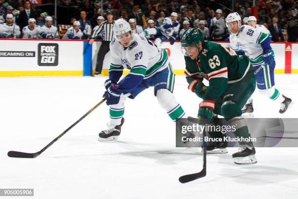 Tyler Ennis of the Minnesota Wild carries the puck past Ben Hutton of the Vancouver Canucks during the game at the Xcel Energy Center on January 14,...