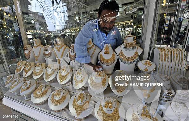 Pakistani worker adjusts jewellery on display at his gold workshop in Rawalpindi on September 9, 2009. Gold prices in Pakistan on September 9 touched...