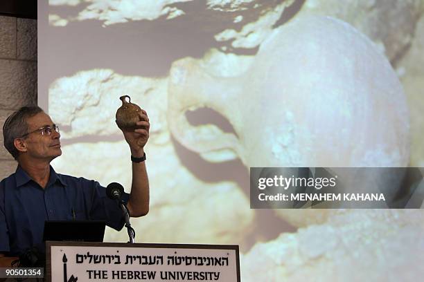 Professor Amos Frumkin of the Hebrew University shows a pottery piece that was recently found along with 120 coins related to the so-called Bar...