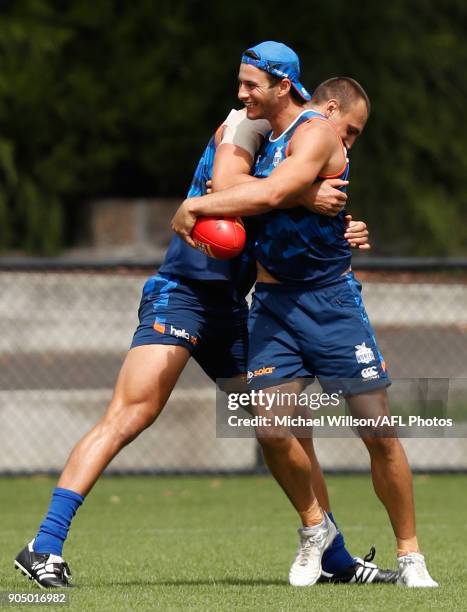 Robbie Tarrant of the Kangaroos is tackled by teammate Braydon Preuss during a North Melbourne Kangaroos Training Session at Arden Street Ground on...