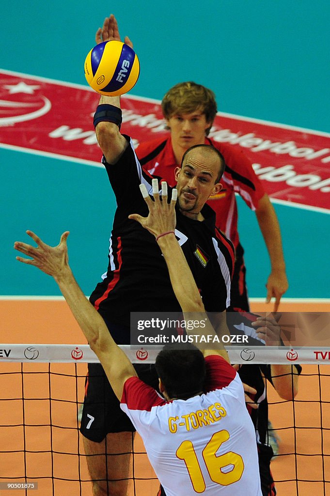 Georg Wiebel (top) of Germany spikes the
