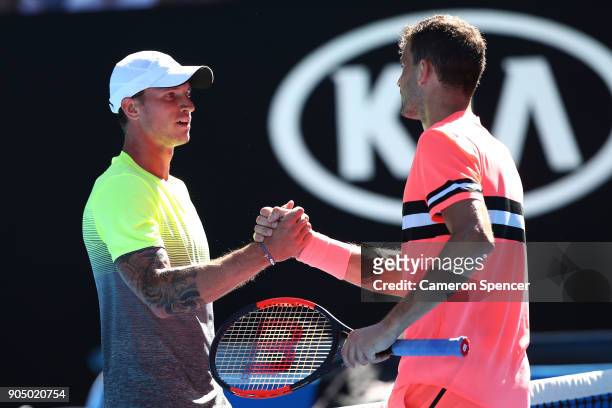 Dennis Novak of Austria congratulates Grigor Dimitrov of Bulgaria after winning his first round match on day one of the 2018 Australian Open at...