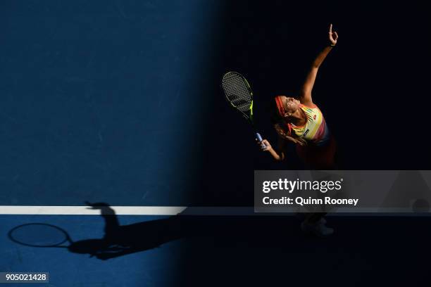 Monica Puig of Puerto Rico serves in her first round match against Samantha Stosur of Australia on day one of the 2018 Australian Open at Melbourne...