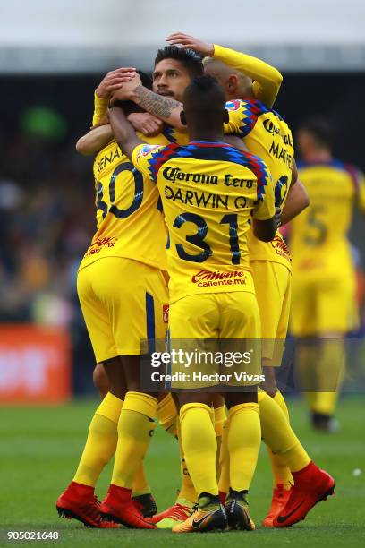 Oribe Peralta of America celebrate with teammates after scoring the first goal of his team during the second round match between America and Pachuca...