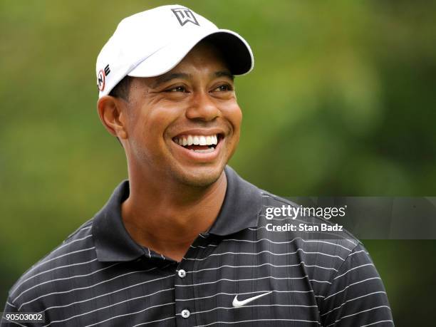 Tiger Woods smiles on the ninth tee box during the Pro-Am round for the BMW Championship held at Cog Hill Golf & Country Club on September 9, 2009 in...