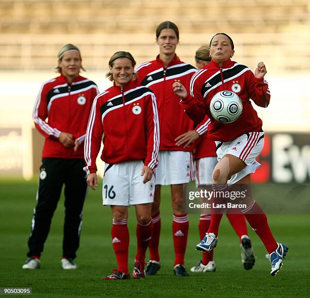 Inka Grings stopps the ball infront of Jennifer Zietz, Martina Mueller and Kerstin Garefrekes during a German National Team training session at the...