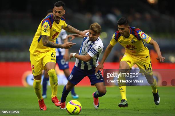 Sebastian Palacios of Pachuca struggles for the ball with Victor Aguilera and Joe Corona of America during the second round match between America and...