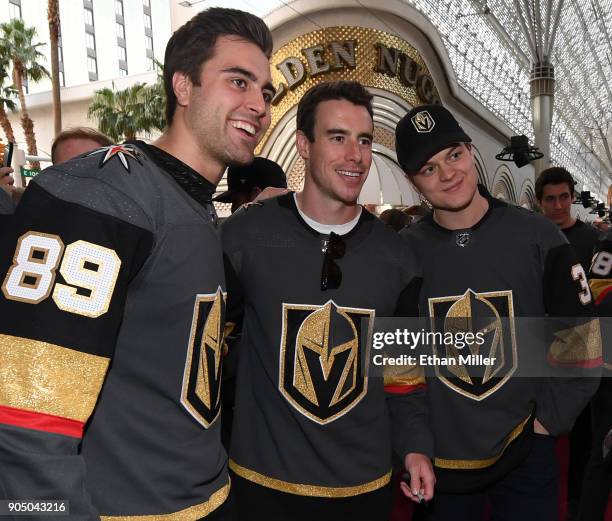 Alex Tuch, Reilly Smith and Reid Duke of the Vegas Golden Knights pose for photos as they walk a red carpet at the Vegas Golden Knights Fan Fest at...