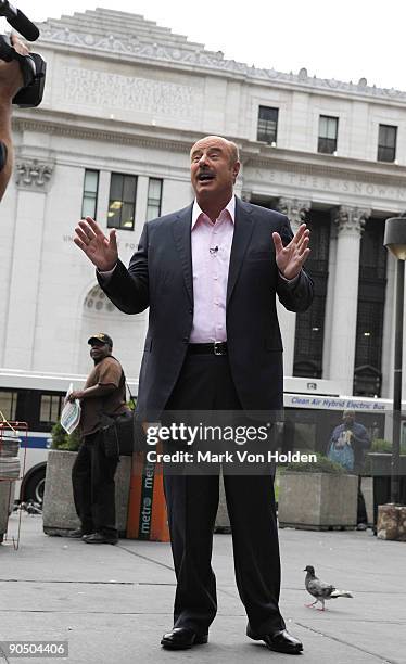 Personality Dr. Phil McGraw talks outside of Penn Station before boarding an Acela express train to Philadelphia during the taping of Phil Hits the...