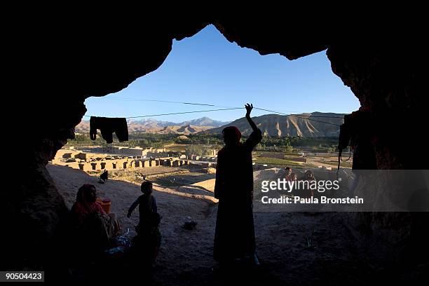 Women and children chat outside their cave dwelling September 7, 2009 in Bamiyan, Afghanistan. Many of the impoverished families living in the caves...