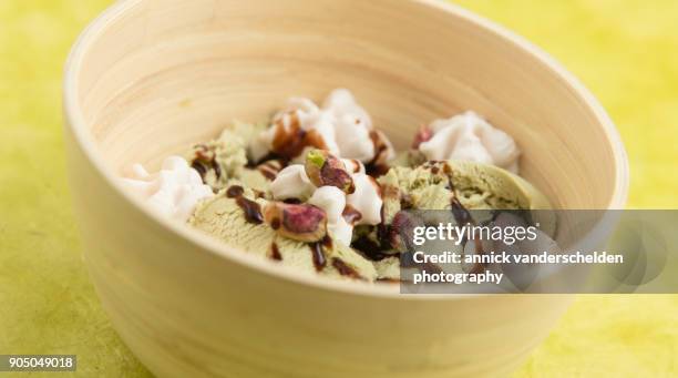 pistachio scoop ice cream served in wooden bowl. - saturated fat stock pictures, royalty-free photos & images