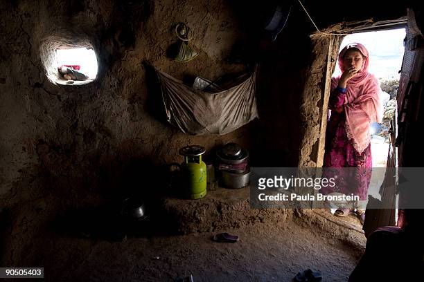 Sukinah peers inside their cave dwelling September 2, 2009 in Bamiyan, Afghanistan. Many of the impoverished families living in the caves say they...