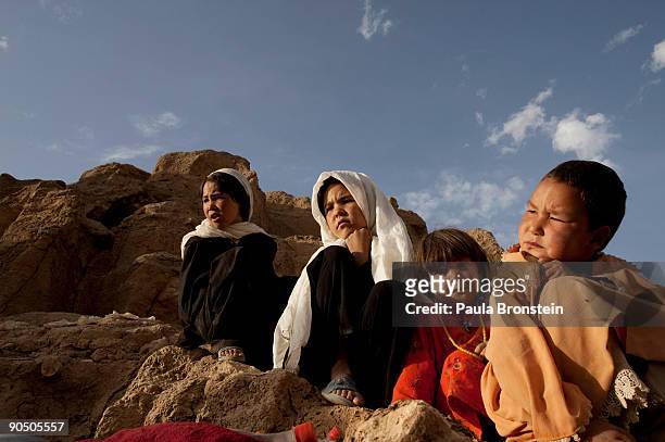 Children sit together near their cave dwellings on September 6, 2009 in Bamiyan, Afghanistan. Many of the impoverished families living in the caves...