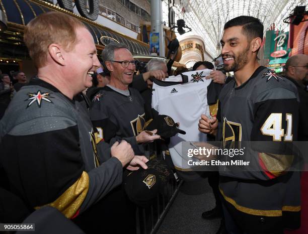 Pierre-Edouard Bellemare of the Vegas Golden Knights signs autographs for fans as he walks a red carpet at the Vegas Golden Knights Fan Fest at the...