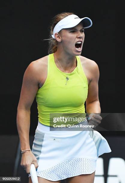 Caroline Wozniacki of Denmark celebrates winning a point in her first round match against Mihaela Buzarnescu of Romainia on day one of the 2018...
