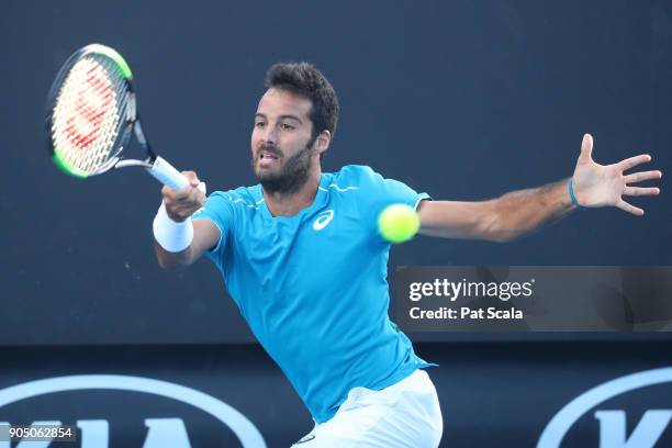 Salvatore Caruso of Italy plays a forehand in his first round match against Malek Jaziri of Tunisia on day one of the 2018 Australian Open at...