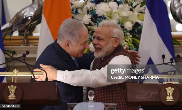 Indian Prime Minister Narendra Modi hugs Israeli Prime Minister Benjamin Netanyahu during a press conference at Hyderabad House in New Delhi on...