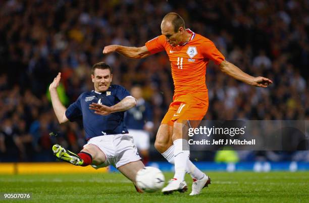 Stephen McManus of Scotland tackles Arjen Robben of Netherlands during the FIFA 2010 World Cup Group 9 Qualifier match beteween Scotland and...