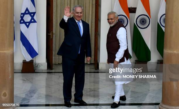 Indian Prime Minister Narendra Modi looks on as Israeli Prime Minister Benjamin Netanyahu waves ahead of a meeting at Hyderabad House in New Delhi on...