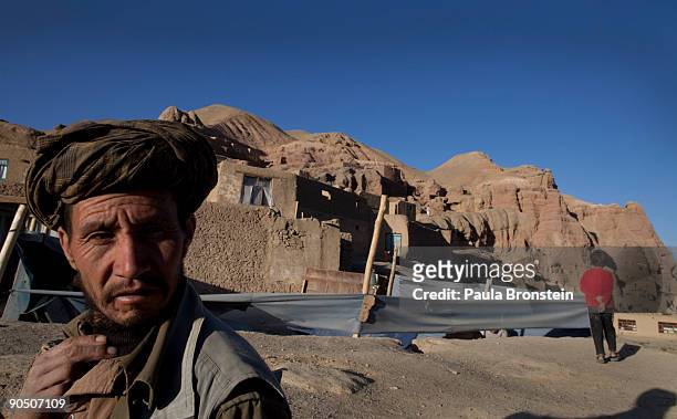 Man looks on as he walks home to his cave September 2, 2009 in Bamiyan, Afghanistan. Many of the impoverished families living in the caves say they...