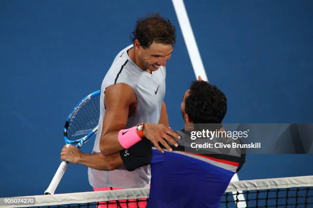 Rafael Nadal of Spain is congratulated by Victor Estrella Burgos of the Dominican Republic after winning their first round match on day one of the...