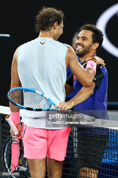 Rafael Nadal of Spain embraces Victor Estrella Burgos of Dominican Republic after winning their first round match on day one of the 2018 Australian...