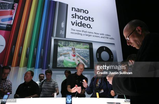 Reporters and special guests look at a display of the new iPod Nano with video capabilities during an Apple special event September 9, 2009 in San...