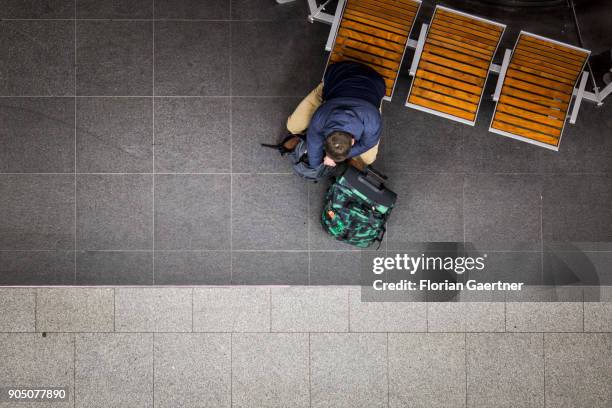 Traveller waits with his bag pack at the main train station on January 11, 2018 in Berlin, Germany.