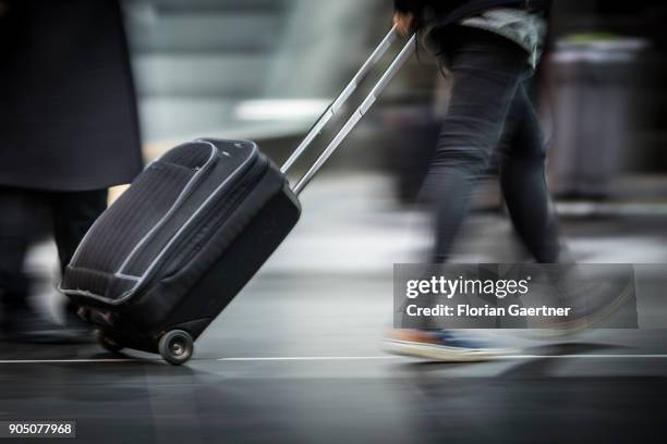 Traveller with trolley bag walks at the main train station on January 11, 2018 in Berlin, Germany.