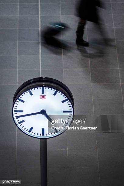 Clock is pictured in front of a walking traveller on January 11, 2018 in Berlin, Germany.
