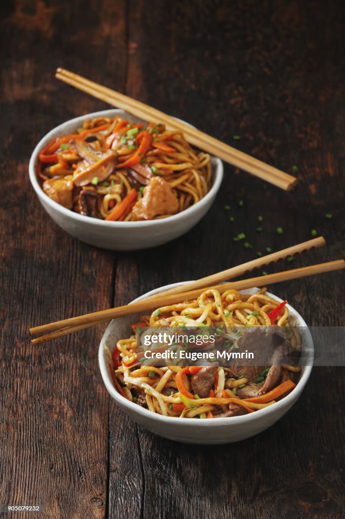 Bowls with chicken, beef and vegetables chow mein