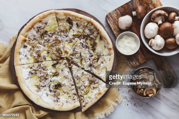 pizza with field mushrooms, porcini mushrooms, mozzarella and truffle sauce - field mushroom stock pictures, royalty-free photos & images