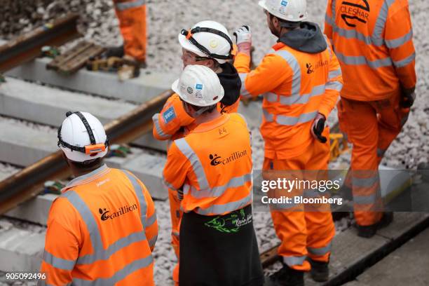 Group of Carillion Plc workers look on during renovation works at London Waterloo train station in London, U.K., on Monday, Aug. 7, 2017. Carillion...