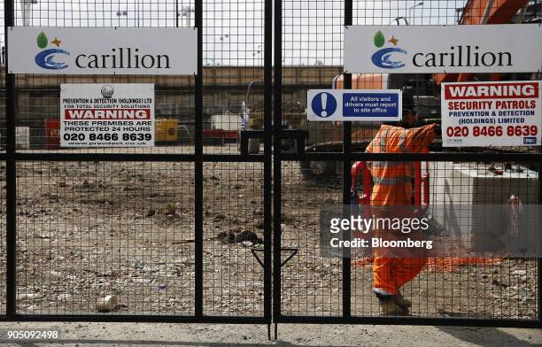 Carillion Plc company logos sit on the gates of a construction site for new apartment blocks built by Carillion Plc in the Canning Town district of...