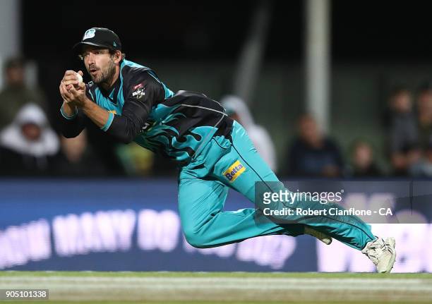 Joe Burns of the Heat takes a catch to dismiss Darcy Short of the Hurricanes during the Big Bash League match between the Hobart Hurricanes and the...