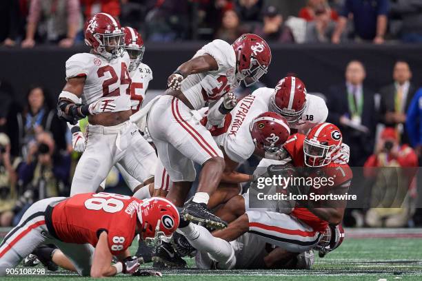 Georgia Bulldogs running back D'Andre Swift is tackled by Alabama Crimson Tide defensive back Minkah Fitzpatrick , Alabama Crimson Tide defensive...