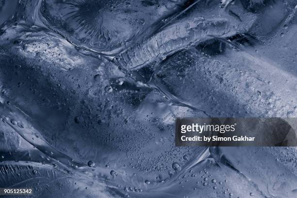 extreme close up of ice floating on water - meniscus stock pictures, royalty-free photos & images