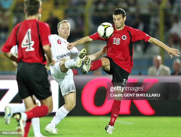 Lars Jacobsen of Denmark vies with Hamdi Salihi of Albania during the FIFA World Cup 2010 qualifying match Albania vs Denmark on September 9, 2009 at...