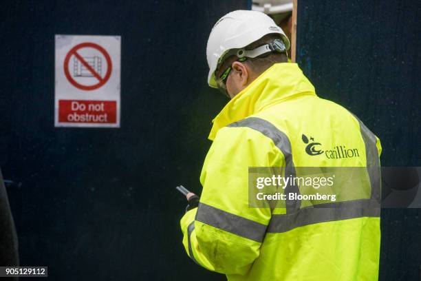 Member of Carillion's staff provides site access to subcontractors to collect their tools on the Barts Square development, operated by Carillion Plc,...