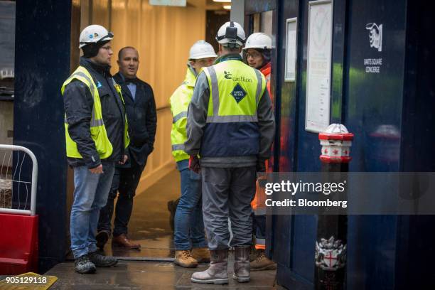 Member of Carillion's staff provides site access to subcontractors to collect their tools on the Barts Square development, operated by Carillion Plc,...