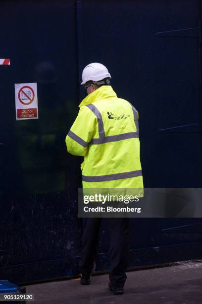 Member of Carillion's staff provides site access to subcontractors to collect their tools on the Barts Square development, operated by Carillion Plc,...