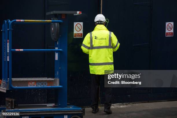 Member of Carillion's staff provides site access to subcontractors to collect their tools on the Barts Square development, operated by Carillion Plc,...